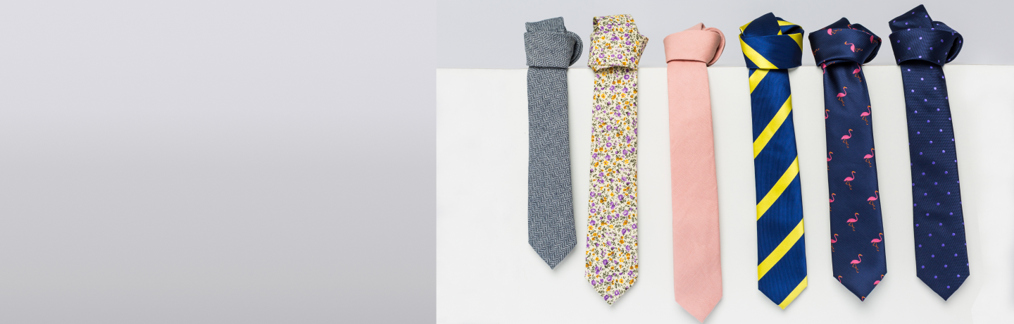 Assorted neckties displayed on a two-tone background.