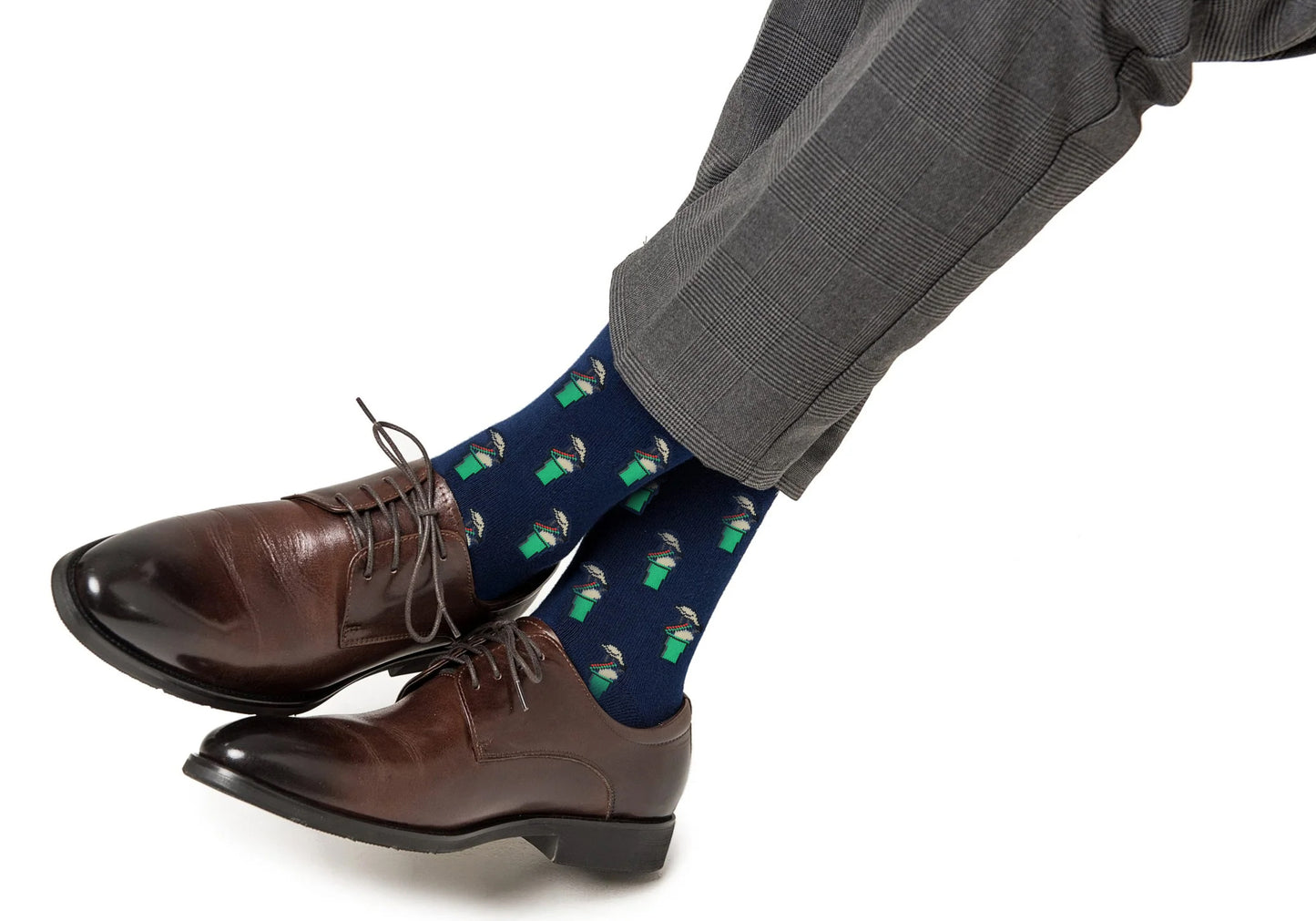 A person wearing gray dress pants, brown oxford shoes, and Basketball Backboard Socks, featuring a navy design with green and white backboard print, sits with legs crossed against a white background.