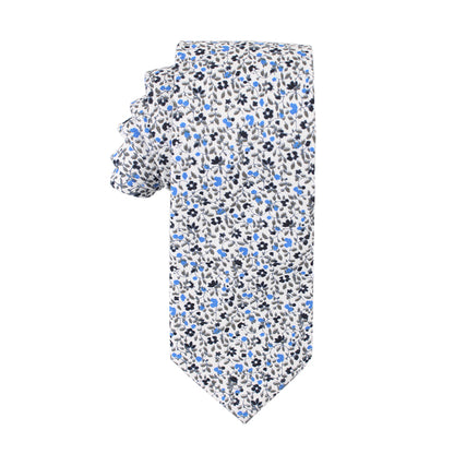 A Black Light Blue Floral Cotton Skinny Tie & Pocket Square Set with blue and white flowers on a midnight backdrop.