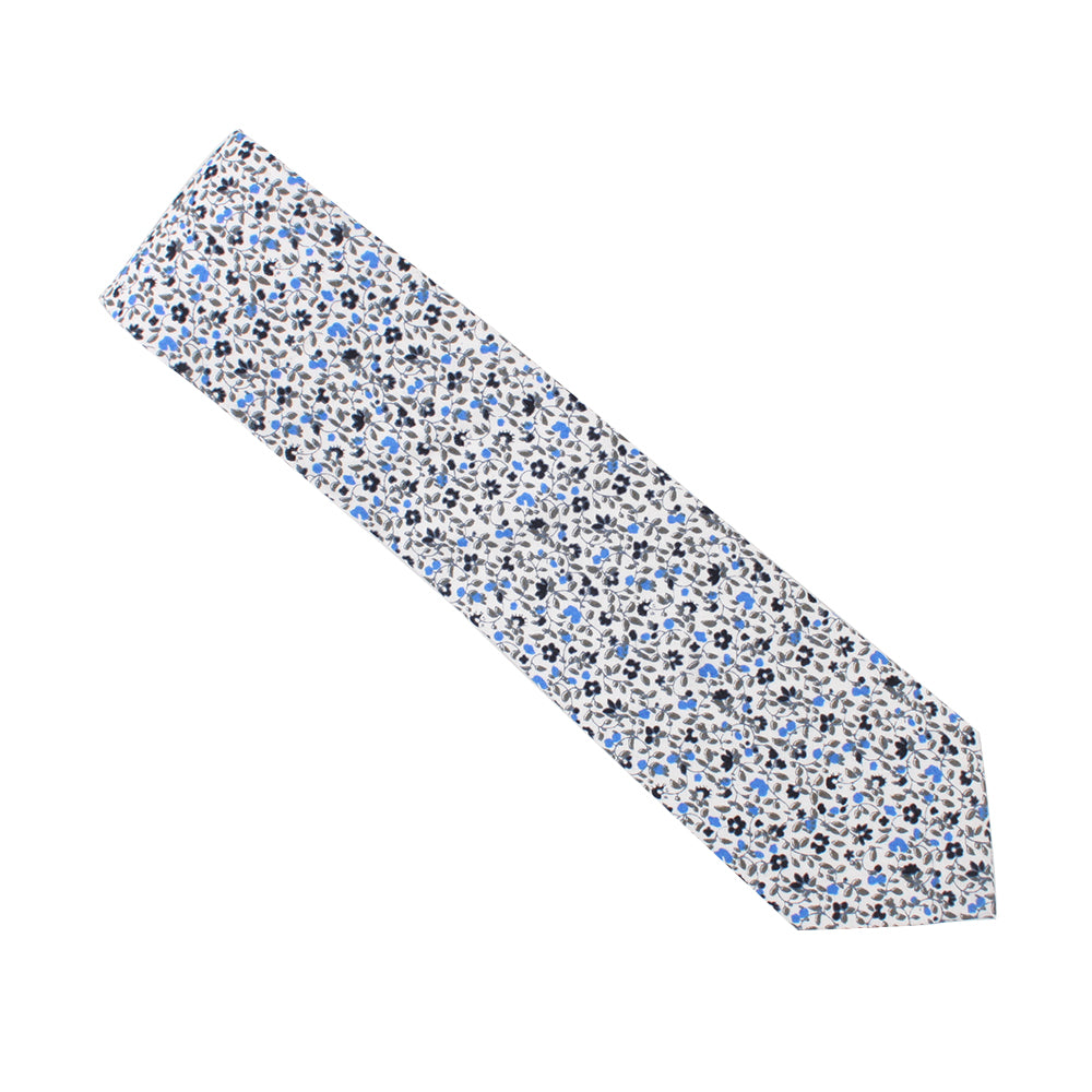 A Black Light Blue Floral Cotton Skinny Tie & Pocket Square Set with blue and white flowers on a Midnight backdrop.