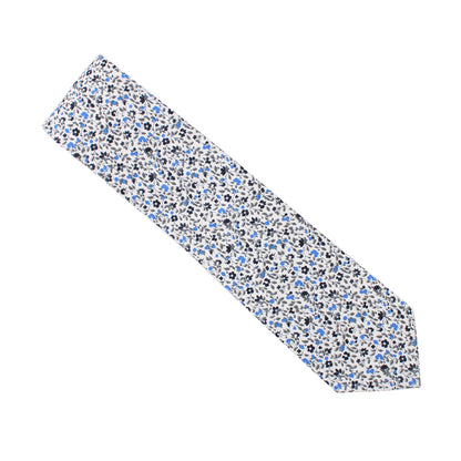 A Black Light Blue Floral Cotton Skinny Tie & Pocket Square Set with blue and white flowers on a Midnight backdrop.