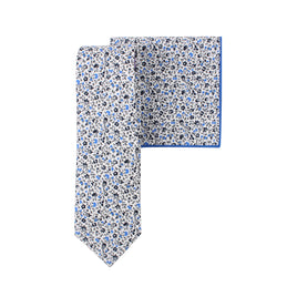 A black light blue floral cotton skinny tie and pocket square against a midnight backdrop.