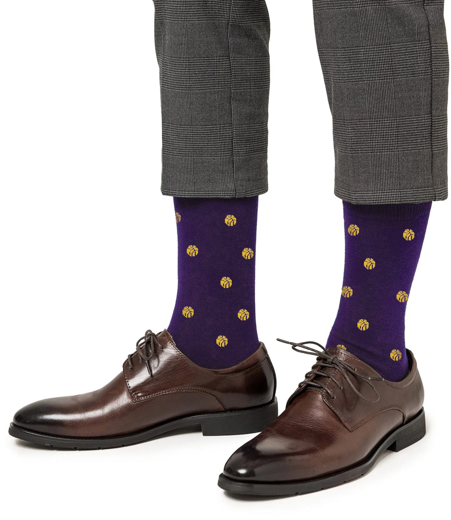 A person wearing gray plaid pants, Yellow Basketball Socks with purple NBA colors, and brown leather dress shoes.