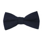 Set against a crisp white background, the Dark Forest Navy Cotton Bow Tie & Pocket Square Set exudes timeless elegance with its smooth, symmetrical shape, adding classic sophistication to any ensemble.