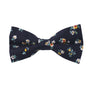 A floral navy cotton bow tie with delicate white, yellow, and orange flowers among green leaves, perfect for pairing with the matching pocket square set.
