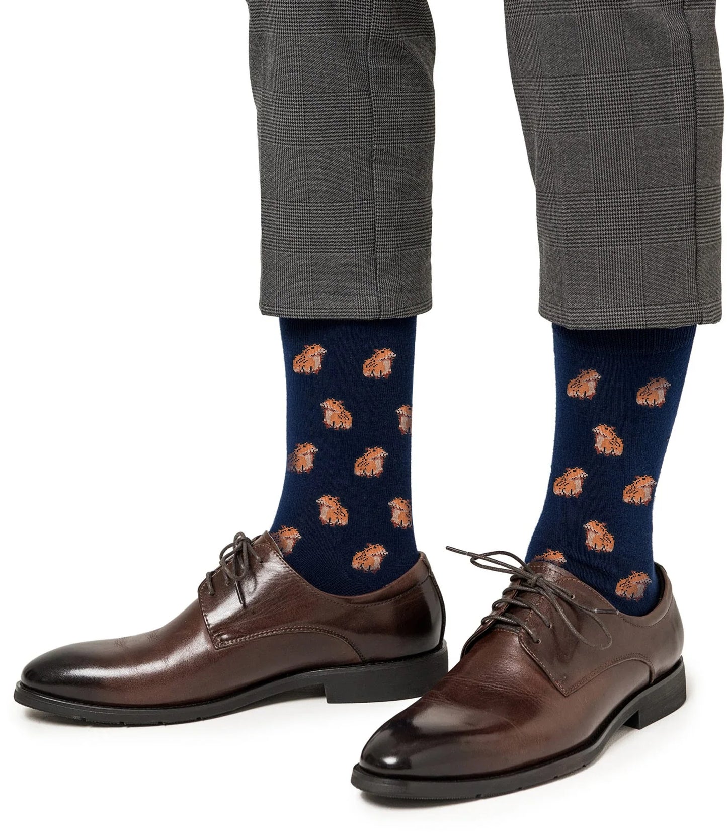A person wearing gray plaid trousers, Bin Chicken Socks, and brown dress shoes.