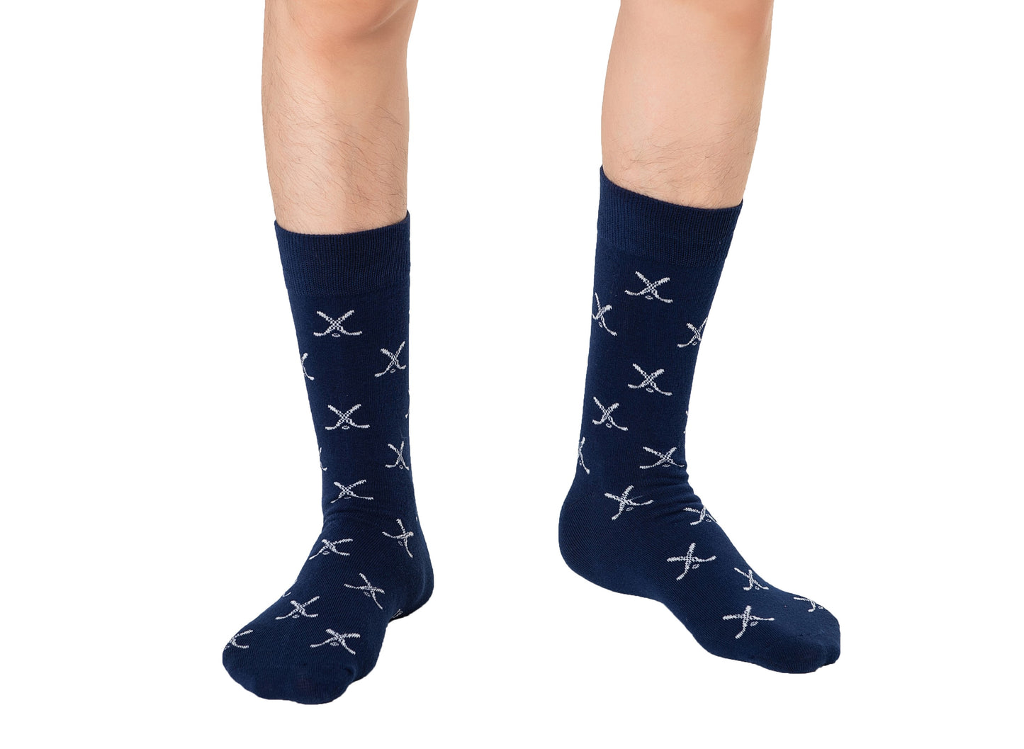 A person stands on a white background, wearing Crossed Ice Hockey Socks in dark blue, featuring a crossed sword pattern. This style subtly hints at a game-inspired performance, seamlessly merging fashion and flair.
