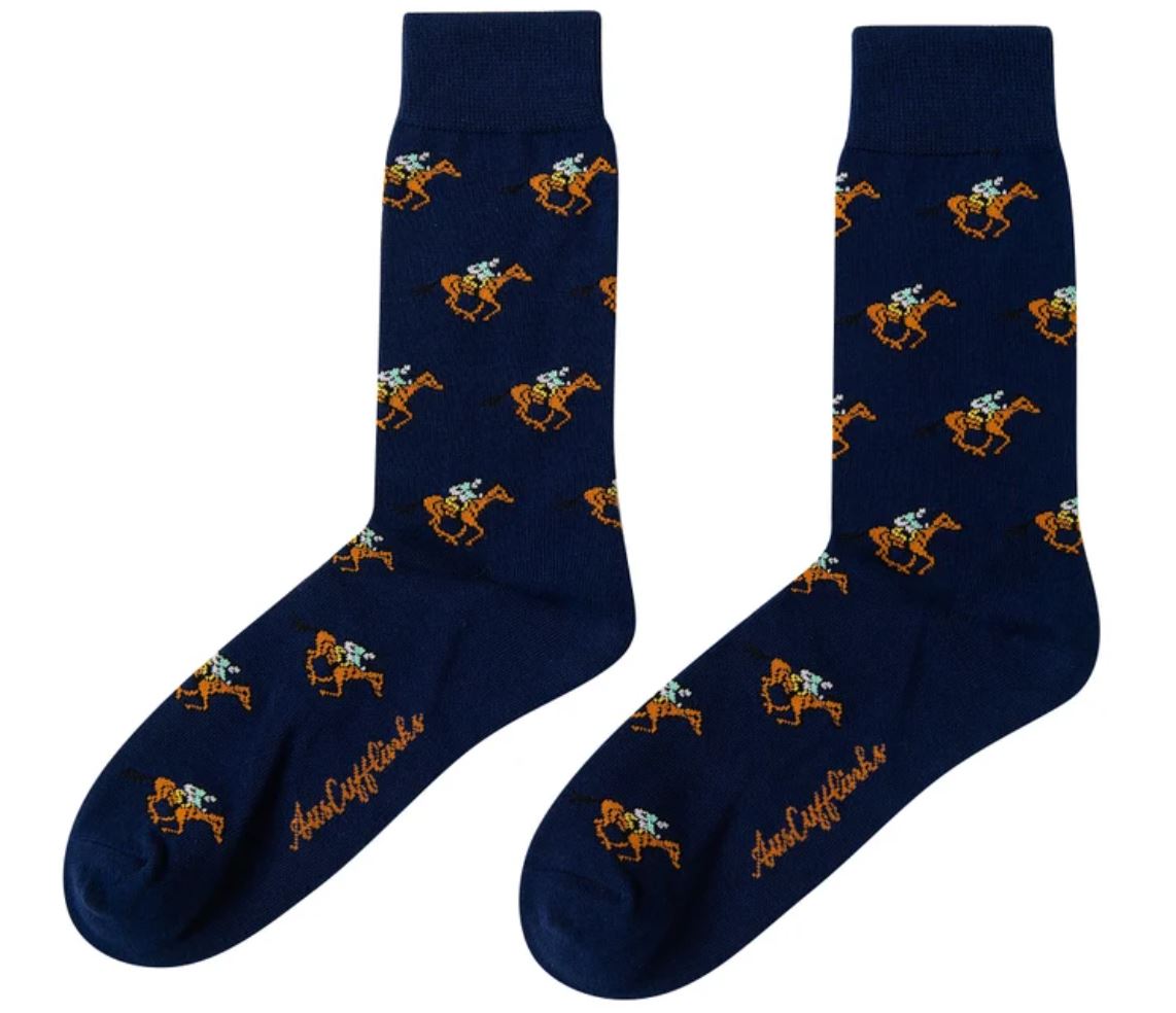 The Horse Racing Socks exude hoofed elegance with their navy blue color and an orange and white horse and rider pattern, featuring a brand logo near the toe.