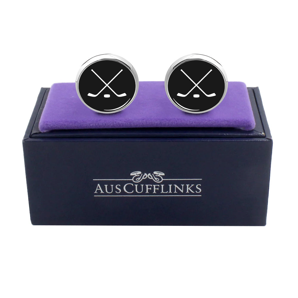 Ice Hockey Cufflinks featuring crossed hockey sticks and a ruby-colored stone, presented in a purple cushioned box labeled "AUS Cufflinks." A timeless gift for any special occasion.