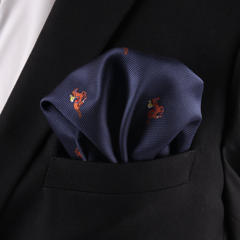 A close-up of the Melbourne Race Horse Pocket Square, featuring a navy blue design with red crab patterns, styled in the breast pocket of a black suit jacketâperfect for Melbourne Cup race day.