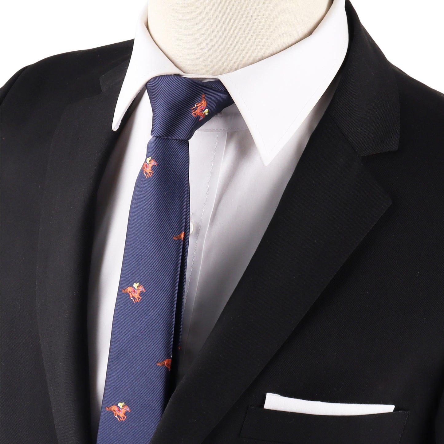A person wears a black suit jacket, white dress shirt, and the Melbourne Race Horse Skinny Tie—its blue design with red rooster patterns adds distinctive equestrian charm and Melbourne Cup flair.