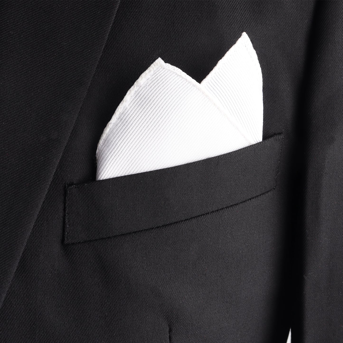 The Men's White Pocket Square adds a touch of refinement to a suit jacket's chest pocket, enhancing its elegance.