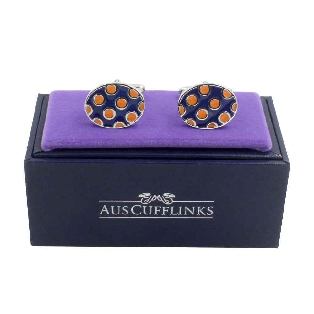 The Ladybug Orange Navy Cufflinks feature a silver design with orange and black polka dots, elegantly displayed on a purple velvet cushion atop a navy box labeled "AusCufflinks," ideal for the modern gentleman.