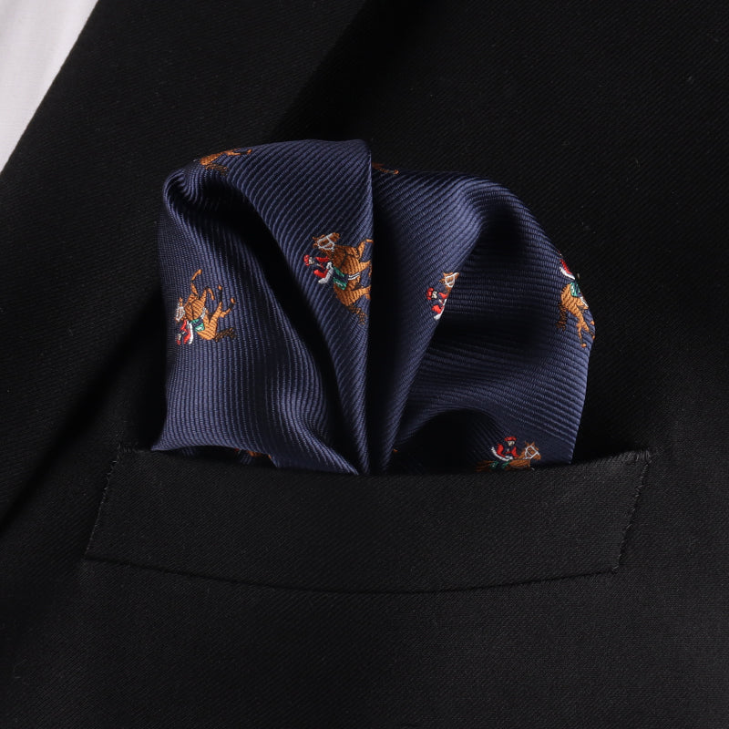 The Thoroughbred Racing Horse Pocket Square, in navy blue with a horse motif, is neatly folded and placed in the breast pocket of a black suit jacket.