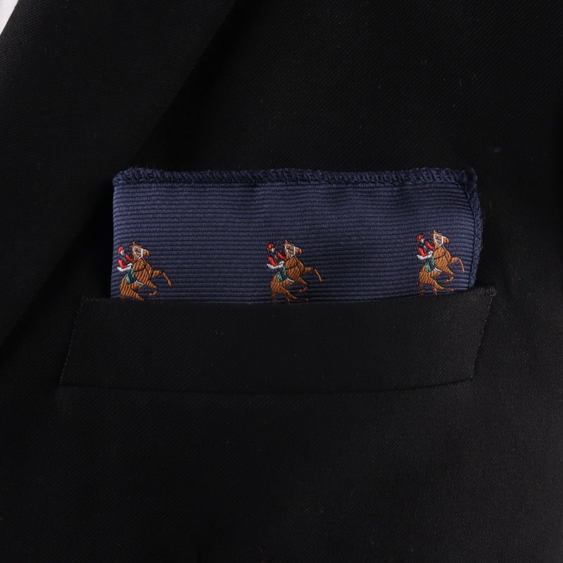 A Thoroughbred Racing Horse Pocket Square in navy blue, featuring embroidered horse and rider designs, accents the pocket of a black blazer.