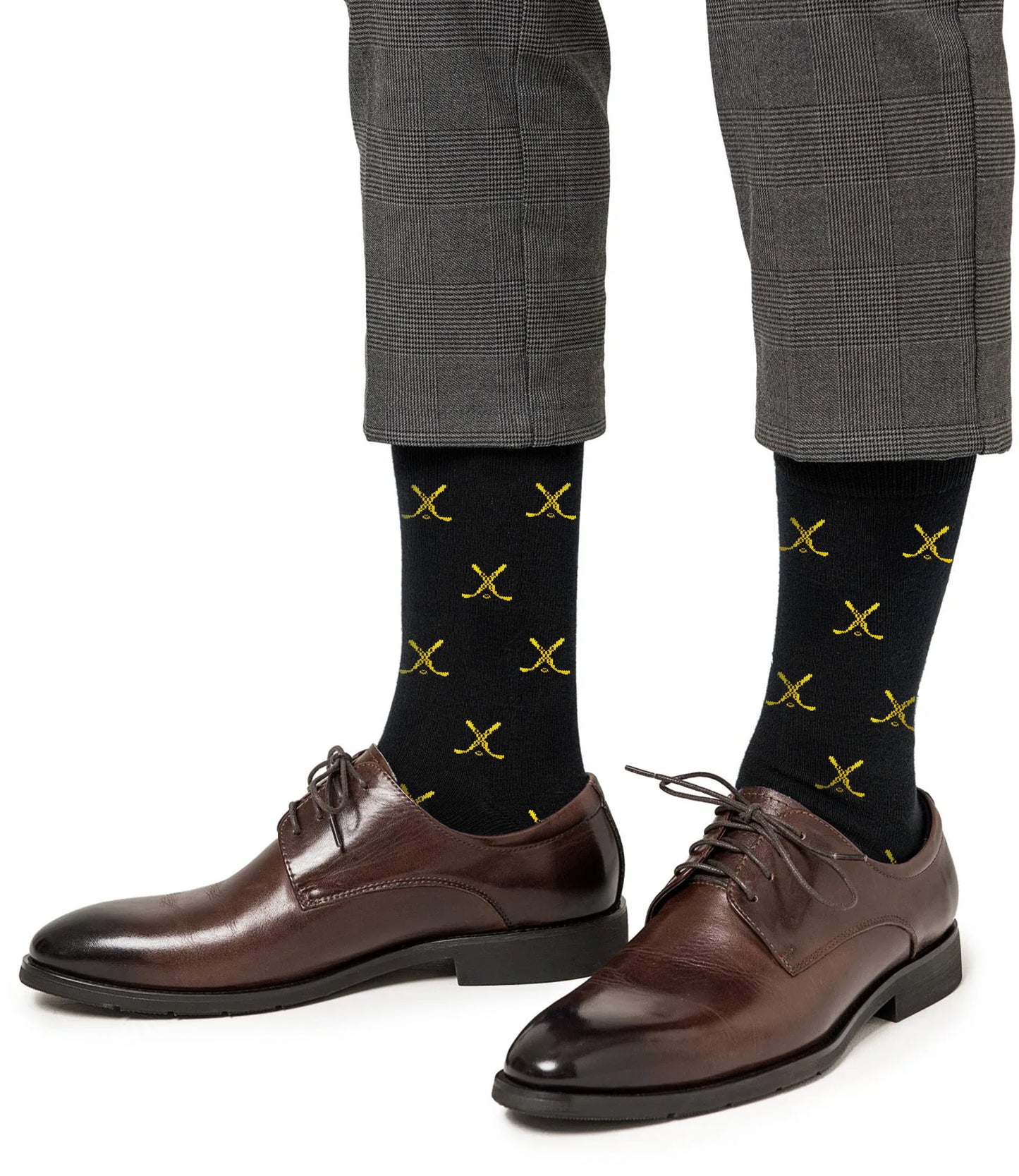 A person wearing gray plaid pants, Yellow and Navy Ice Hockey Cross Socks, and brown dress shoes.