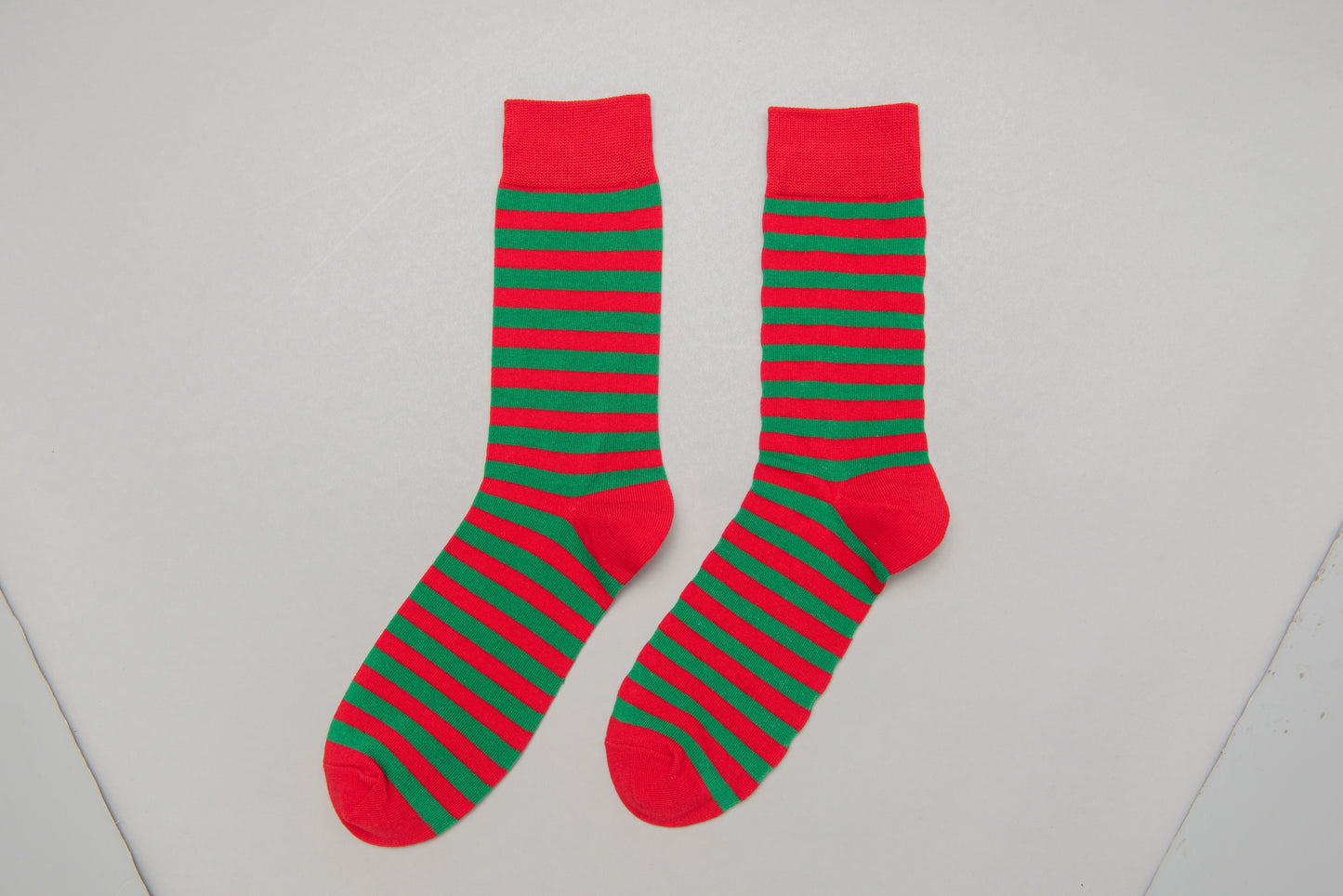 Fun Christmas-themed elf socks for men featuring a green and red festive design