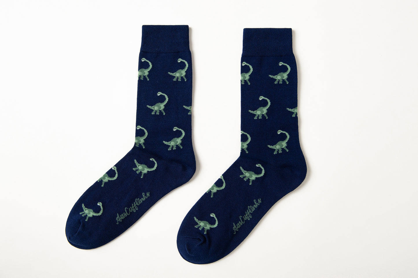 Fun novelty Brontosaurus socks for men featuring green dinosaur design on navy background