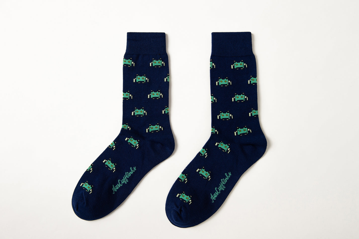 Fun novelty gamer socks for men featuring green space invader design on navy background