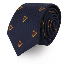 A Harp Skinny Tie rolled up, featuring a pattern of small orange and gold shield motifs, designed to orchestrate elegance, isolated on a white background.