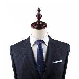 A powerful mannequin displaying grace, dressed in a suit and tie with an Eagle Skinny Tie detail.