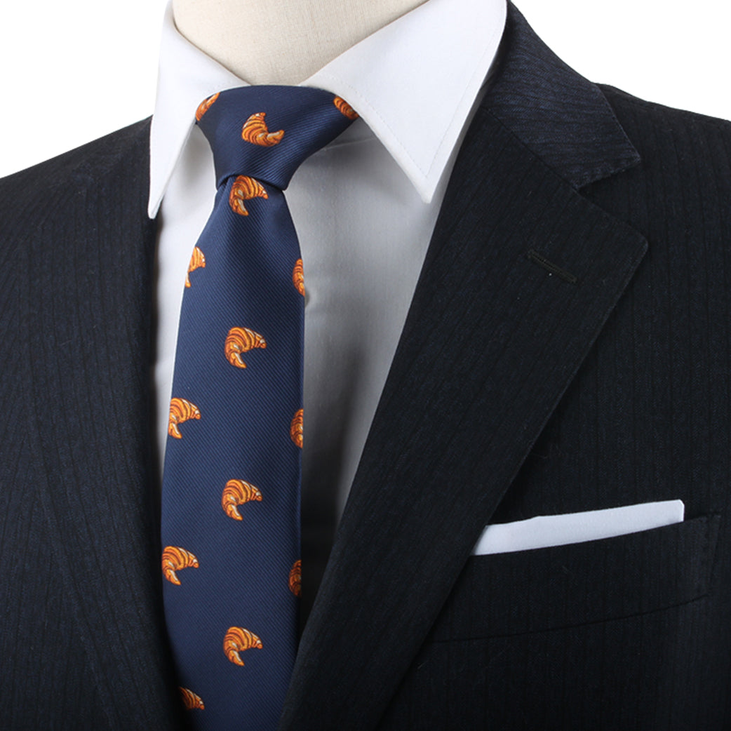 A mannequin sporting a stylish blue suit and Croissant Skinny Tie.