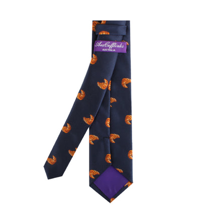 A Croissant Skinny Tie with orange and black foxes on it.