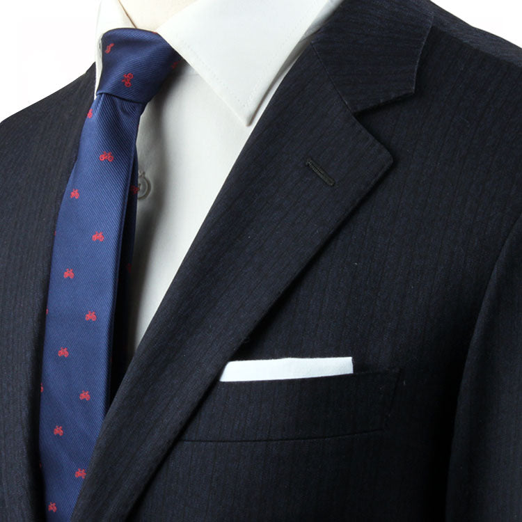 A mannequin wearing a suit and tie, with a Cyclist Skinny Tie pattern.