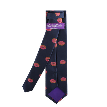 A Donut Skinny Tie with pink and orange circular patterns, designed to spark engaging conversations, features a label at the neck indicating the brand "geoffrey beene.