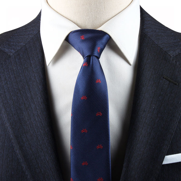A mannequin wearing a suit and tie with a Cyclist Skinny Tie pattern.