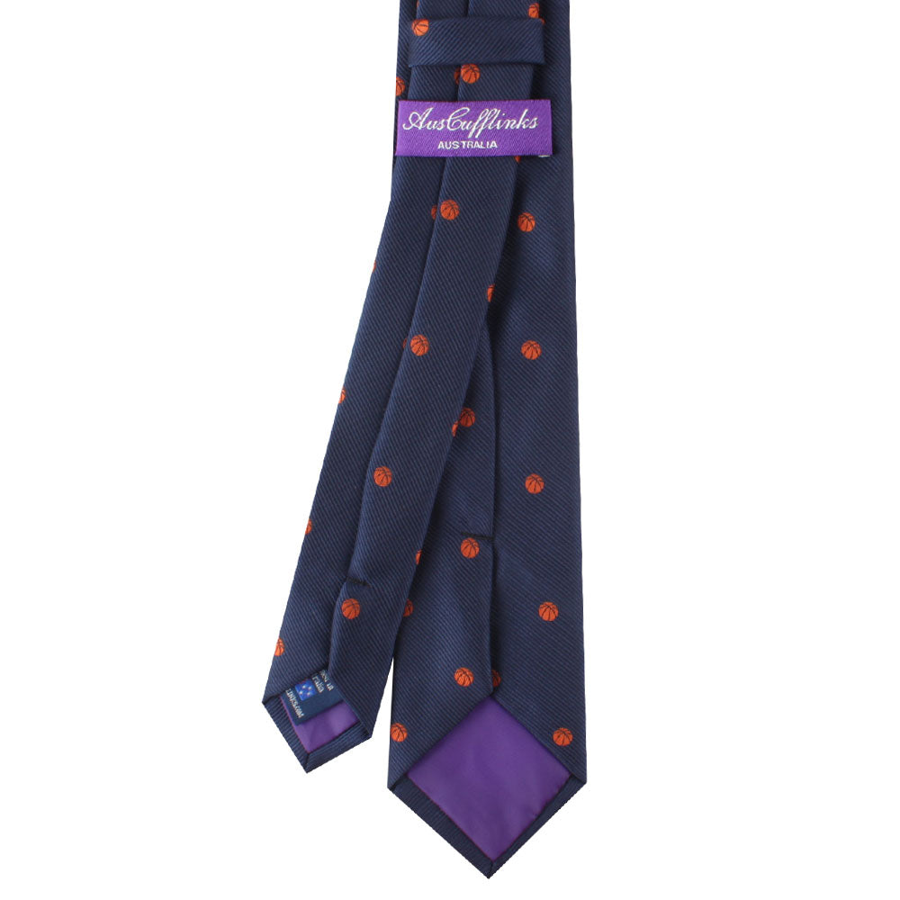 A Basketball Skinny Tie with orange and blue polka dots, perfect for adding a touch of sports spirit to your outfit.