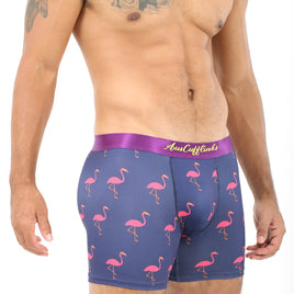 A man wearing Pink Flamingo Underwear exudes tropical vibes, showing his tattooed torso.