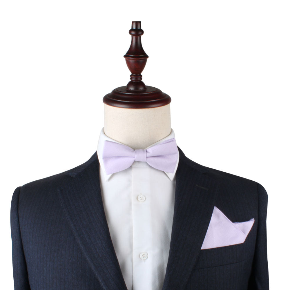 A mannequin with a bow tie and Blush Purple Pocket Square elegance.