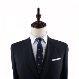 Mannequin torso displaying a navy suit with a Pancakes Skinny Tie and pocket square.