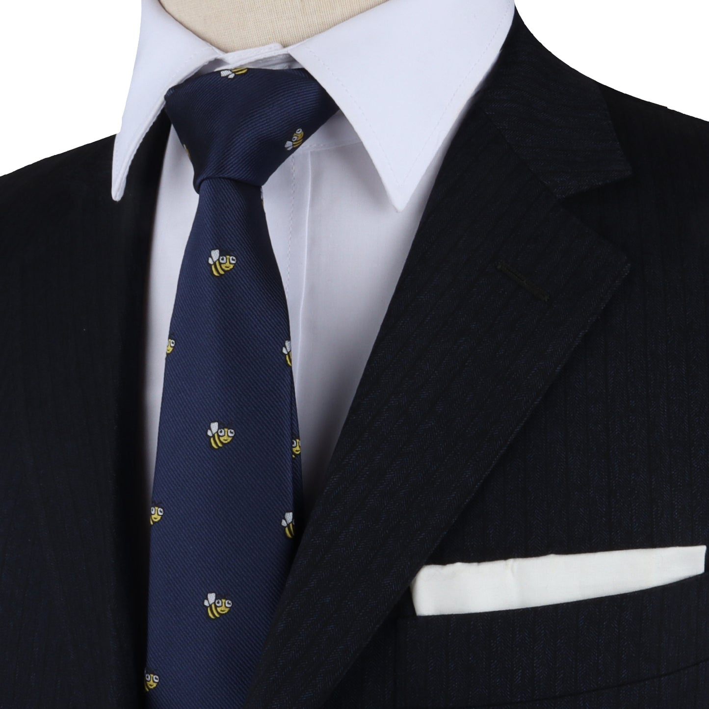 A mannequin exuding allure in a stylish suit, Bee Skinny Tie, and pocket square.