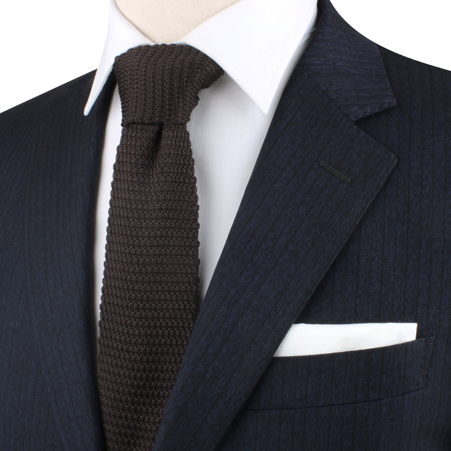 A mannequin wearing a suit and tie with a Brown Knitted Skinny Tie.