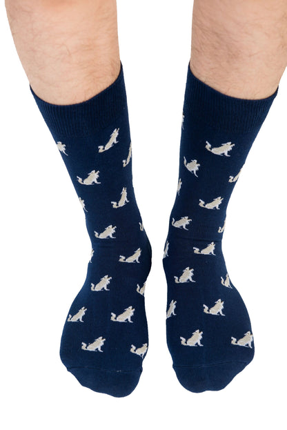 A pair of legs wearing Wolf Socks adorned with bird patterns takes every step against a white background, leading the pack.
