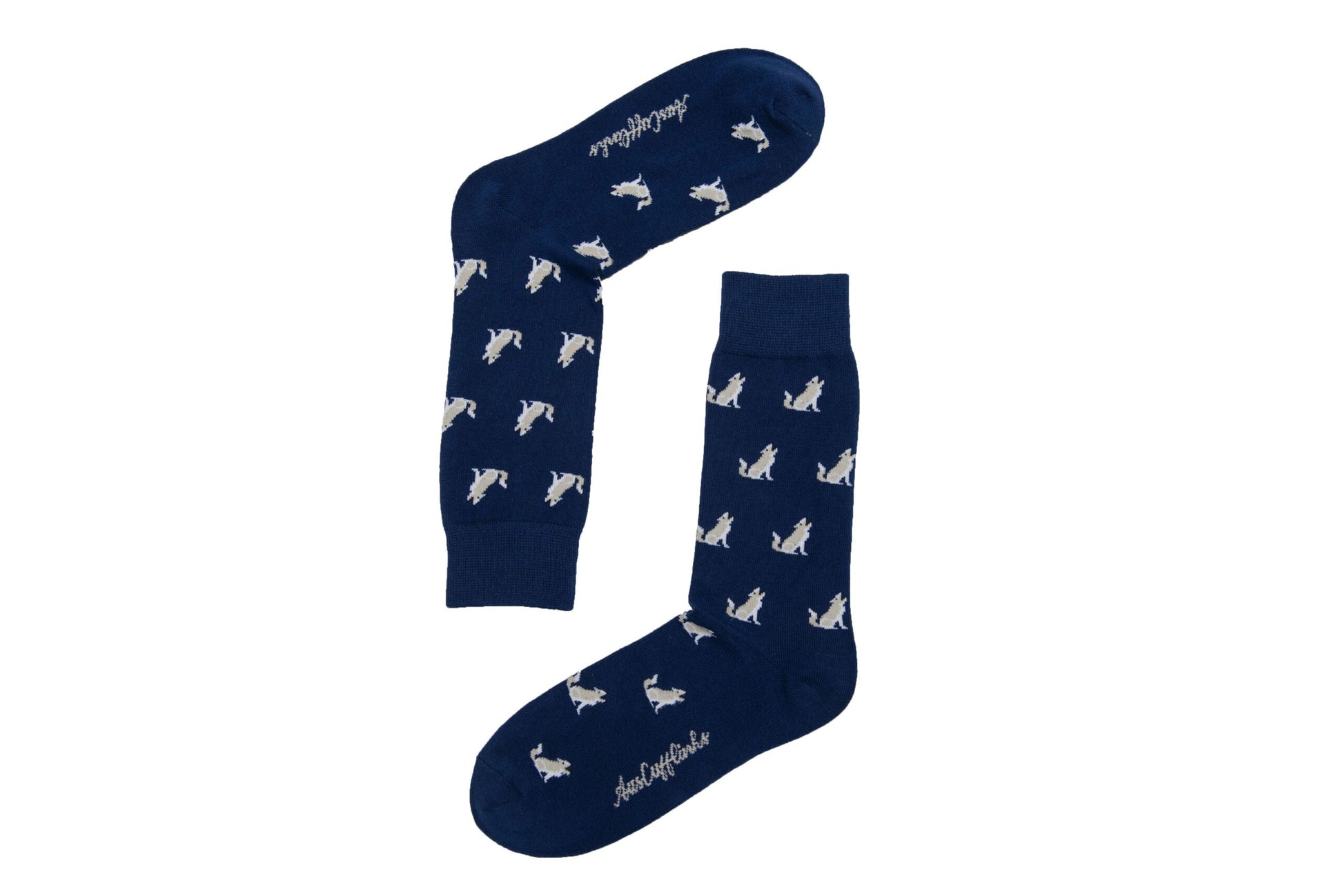 A pair of navy blue Wolf Socks with white dog print and non-slip "lead the pack with every step" text on the sole.