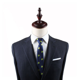 A mannequin dressed in a dark suit, Green Turtle Skinny Tie, and white pocket square exuding natural elegance against a plain background.