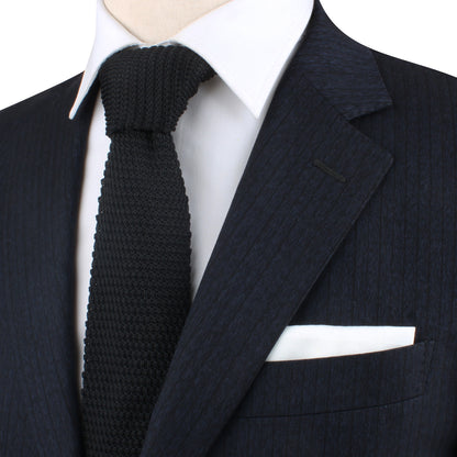 A mannequin exuding classic charm in a Black Knitted Skinny Tie and suit.