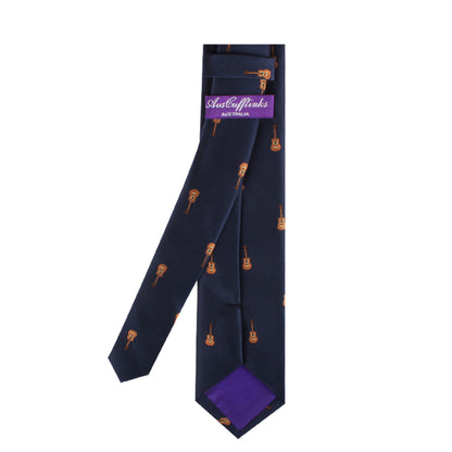 Guitar skinny tie with orange guitar patterns expressed in melodic passion and a purple tail, displayed against a white background.