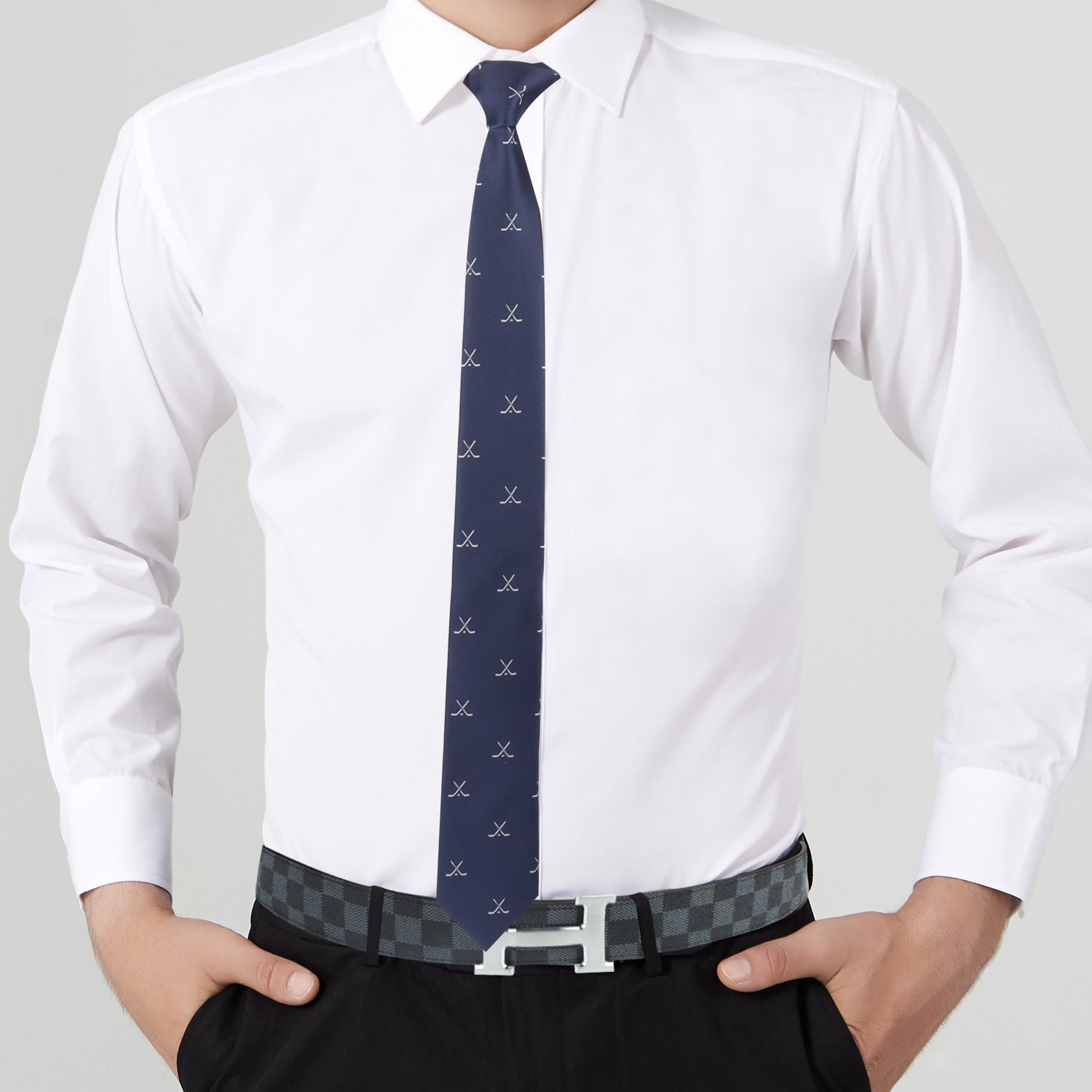 A man wearing a Crossed Ice Hockey Skinny Tie is oozing style points while sporting a white shirt.