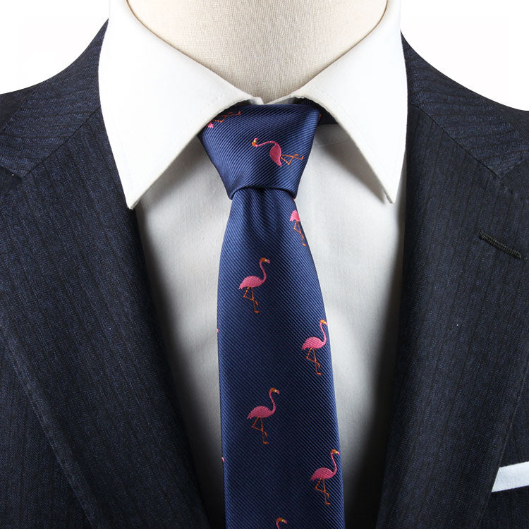 Close-up of a mannequin wearing a navy blue suit and white shirt, accented with a Pink Flamingo Skinny Tie that adds tropical elegance.