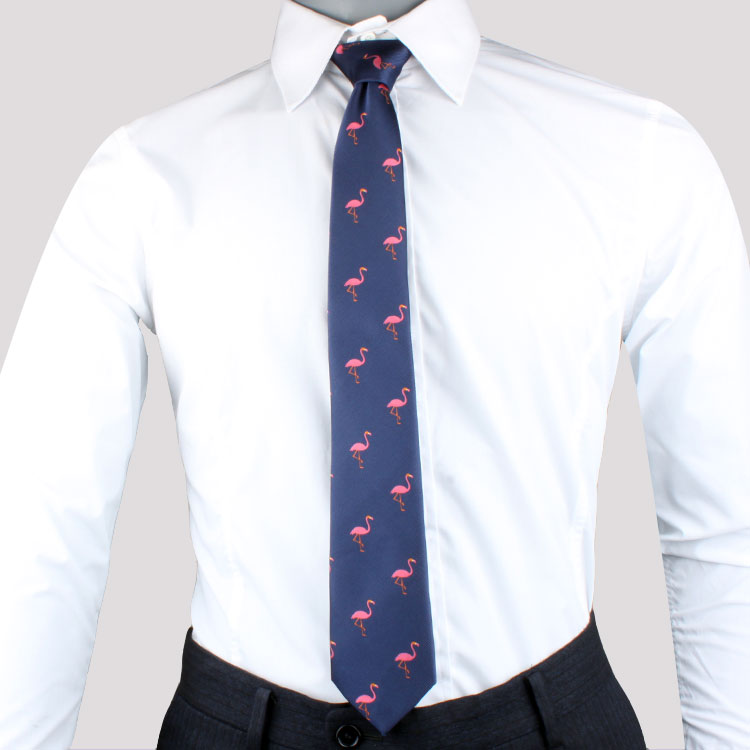 Man wearing a white shirt and dark trousers, sporting a navy Pink Flamingo Skinny Tie.