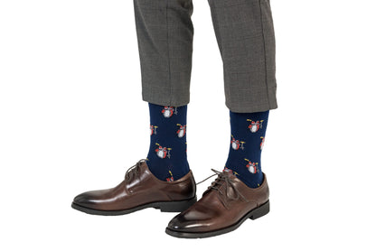 A man sporting a vibrant pair of Drum Socks with penguins on them.