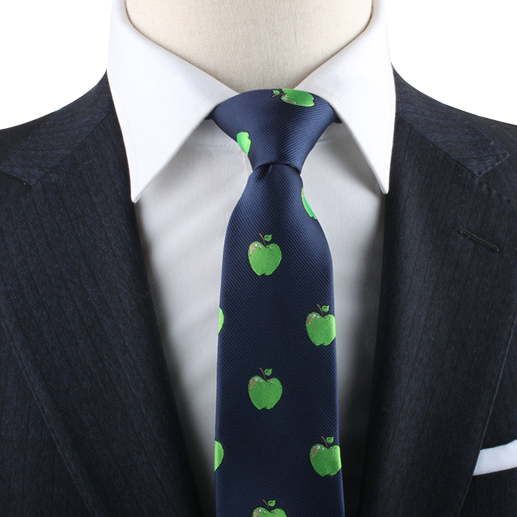 A person wearing a dark suit and white dress shirt with an Apple Print Tie, exuding modern style and natural freshness.