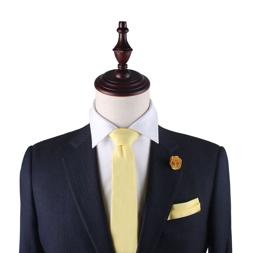 A playful Baby Yellow Cotton Skinny Tie & Pocket Square Set on a mannequin dummy.