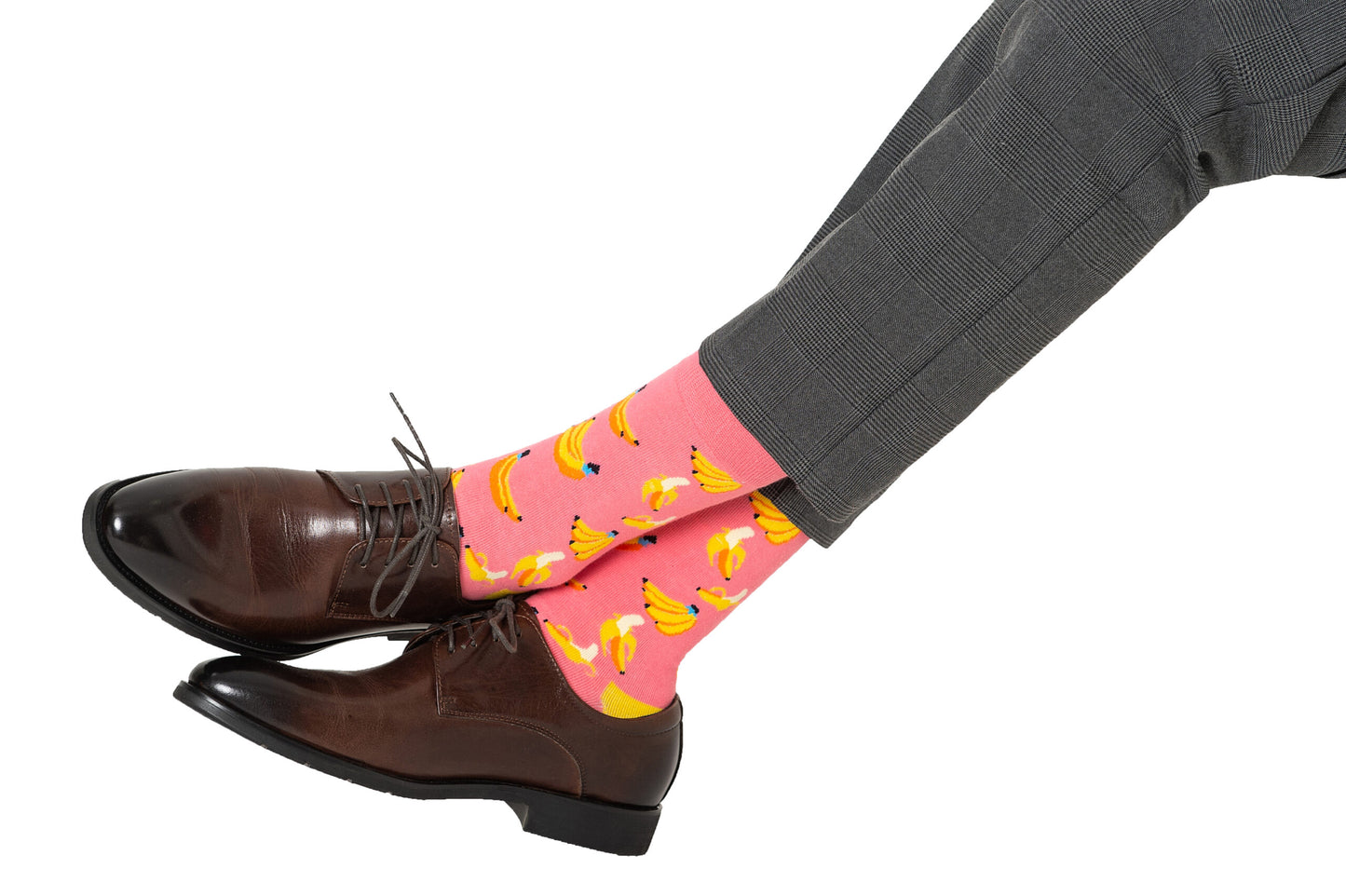 A man wearing Banana Pink Socks and classic brown shoes.