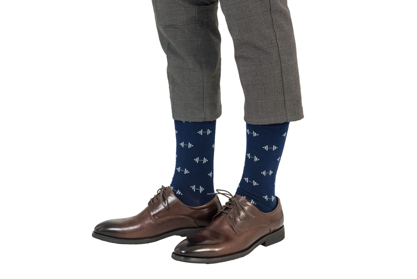 A pair of legs wearing brown shoes and Gym Socks.