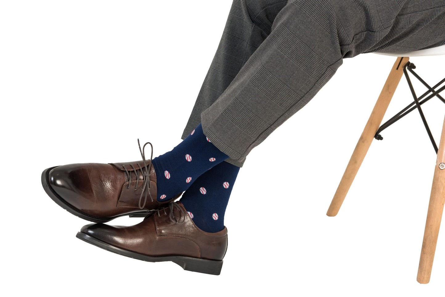 A man wearing Baseball Socks is sitting on a chair.
